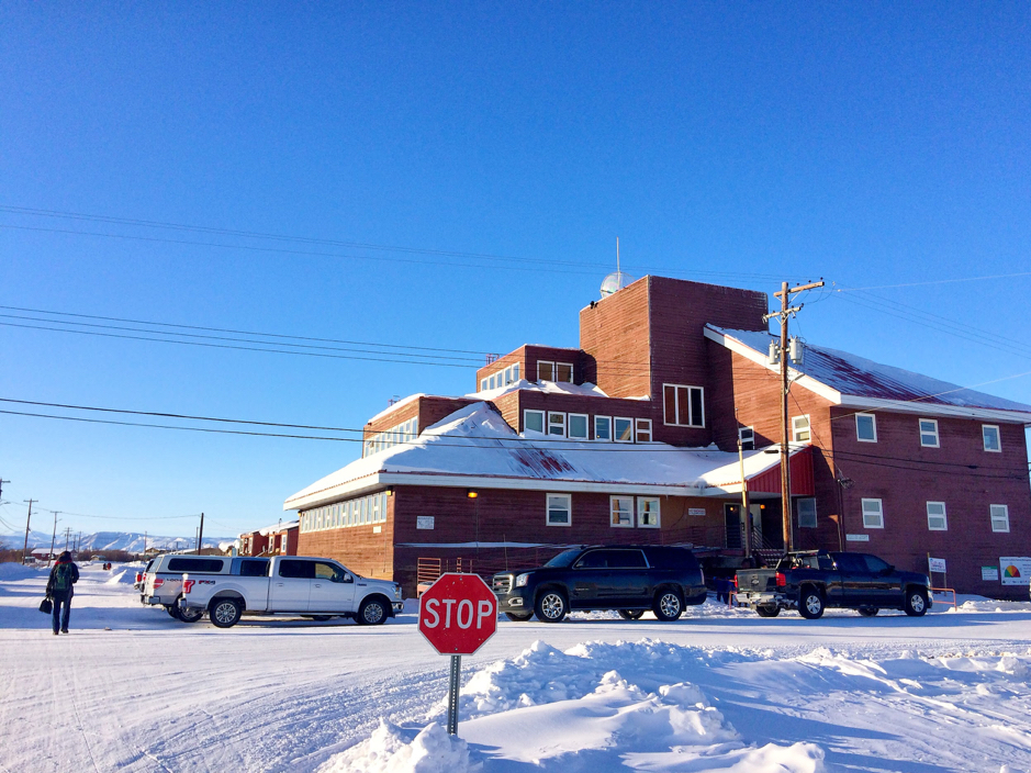 The Takuvik team meets with Senior Administrative Officer, Fred Behrens in Aklavik, Northwest Territories, Canada, February 25, 2019. On this picture, Marie-Hélène Forget (left) walking towards the “Big Building”, where many social, municipal and community affairs take place. ©Martine Lizotte Takuvik2019 Picture2 13