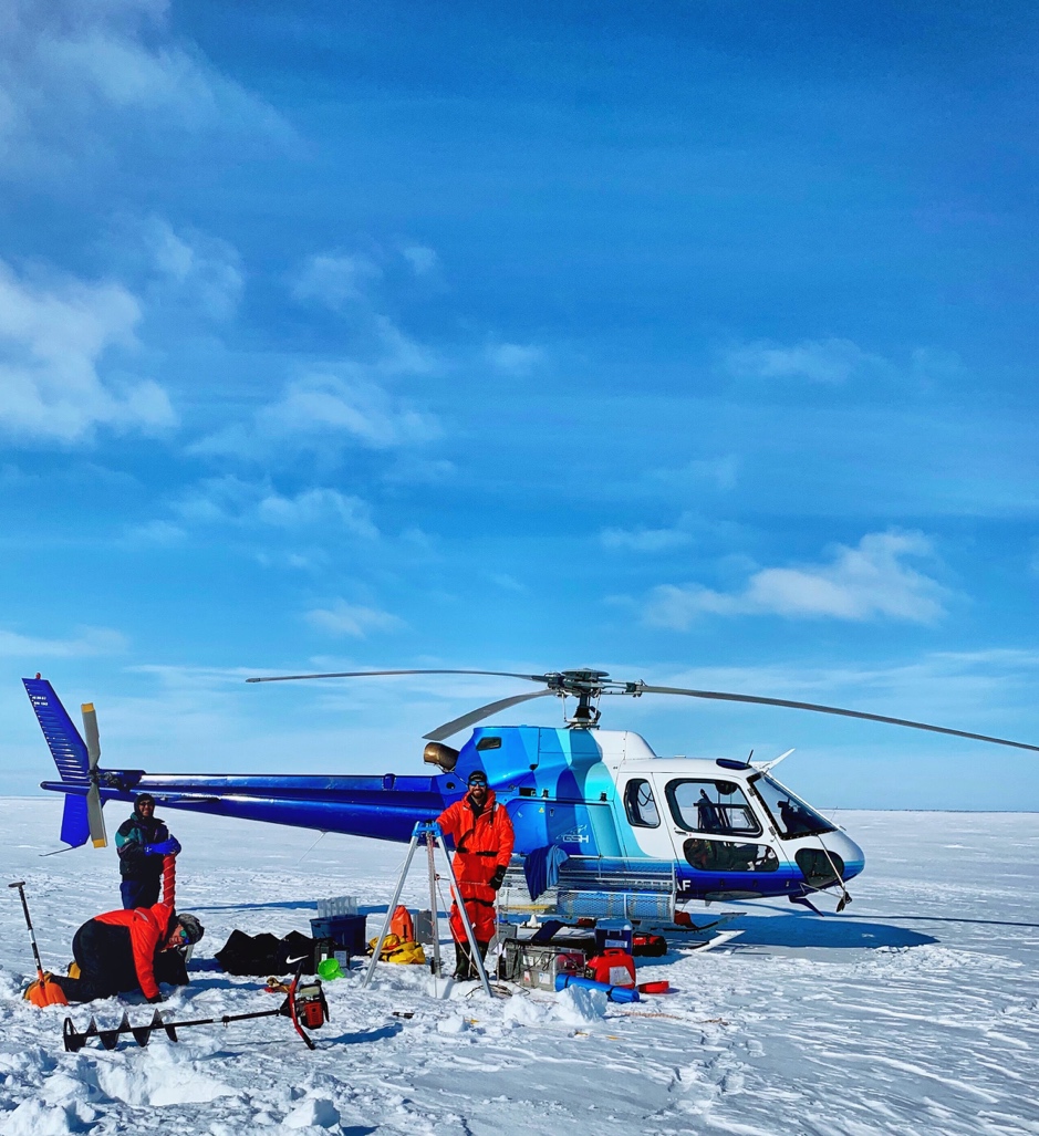 Miles Dillon (left standing), Bennet Juhls (left kneeling) and Laurent Oziel (right) sampling in the sunny Western Sector of the Mackenzie Delta, April 22, 2019. Photo credit Connor Gould, pilot and assistant Inuvik base manager for Great Slave Helicopters (GSH). Takuvik2019 Picture5 3 web