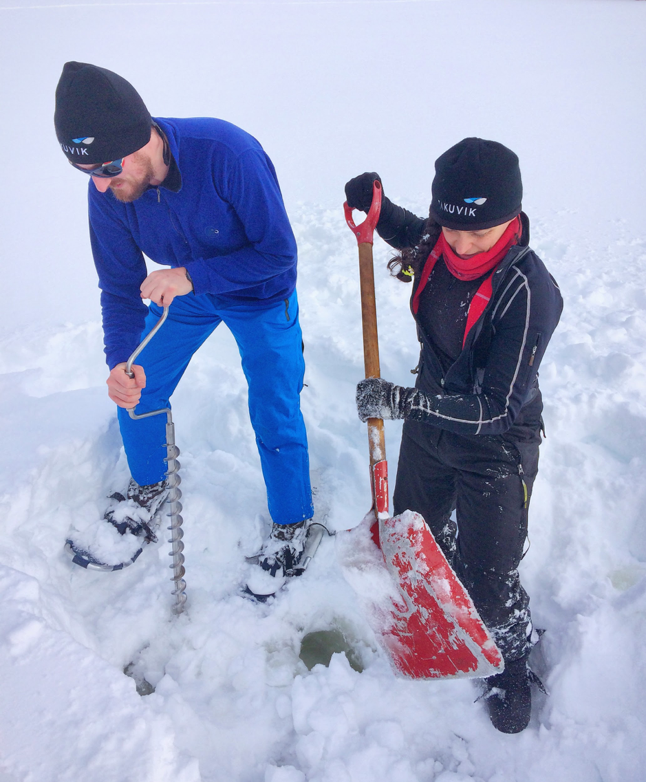 Christian Katlein makes a rapid check of ice thickness using a hand-cranked drill and Joannie Ferland shovels snow to uncover the surface of the ice over Piché Lake, Forêt Montmorency, Canada, February 4, 2019. ©Martine Lizotte. Takuvik spring prep 2019 M.Lizotte Picture3